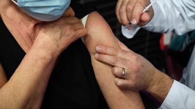 An elderly woman receives a dose of the Pfizer-BioNtech Covid-19 vaccine at a vaccination centre in Garlan, western France. AFP