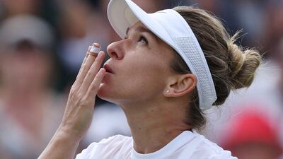 Romania's Simona Halep celebrates beating Poland's Magdalena Frech at Wimbledon on July 2, 2022. AFP