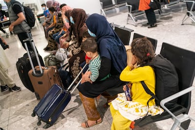Refugees from Afghanistan wait to be processed after arriving on a evacuation flight at Heathrow Airport. Getty Images