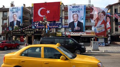 Cars drive past posters for presidential candidates Turkey's President and ruling Justice and Development Party, or AKP, leader Recep Tayyip Erdogan, left, and Meral Aksener, the presidential candidate of nationalist opposition Iyi (Good) Party in Ankara, Turkey, on June 24, 2018. Ali Unal / AP Photo