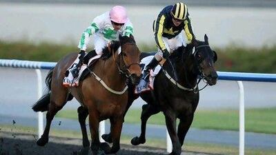 Silvestre de Sousa, in white, takes Hitchens home in the Al Shindagha sprint yesterday.