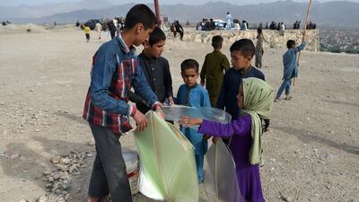 An Afghan boy sells plastic kites to children on a hillside in Kabul.