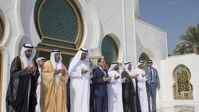 Abdel Fattah El Sisi, president of Egypt, centre, prays at the tomb of the Sheikh Zayed,near the Grand Mosque on Wednesday. Among those who accompanied him are Dr Sultan Al Jaber, third from left, Minister of State, Chairman of Masdar and Chairman of the Abu Dhabi Ports Company, Mohammed Al Dhaheri, fifth from left, the UAE Ambassador to Egypt, and Dr Hamdan Al Mazrouei, second left, chairman of the board of directors of the Emirates Red Crescent. Mohamed Al Hammadi / Crown Prince Court – Abu Dhabi