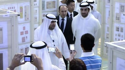 Khoory, left, and Sheikh Sultan bin Ahmed bin Sultan Al Qasimi, at the 28th Asian International Stamp Exhibition. Jeffrey E Biteng / The National