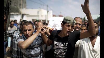 Mourners carry the body of Palestinian Huweshil Abu Huweshil, from his house to the mosque during his funeral procession south of Gaza City. Mahmud Hams / AFP