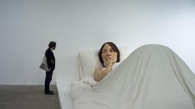 A visitor looks at the sculpture 'In bed' by Australian artist Ron Mueck on display during the exhibition Vivid Memories at the Fondation Cartier Museum in Paris, France, May 9, 2014. The exhibition celebrates the 30th anniversary of the Cartier Foundation by focusing on the works the museum has collected since 1984. The exhibition runs from May 10 to September 21 2014. EPA
