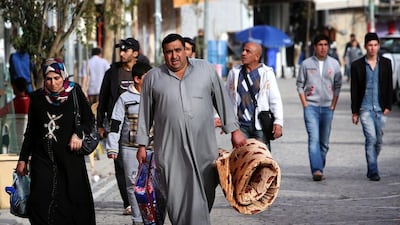 Displaced Iraqis who fled their hometown of Fallujah due to unrest between government forces and militants in the flashpoint Anbar province walking in the Kurdish town of Shaqlawa of March 6. Safin Hamed / AFP Photo