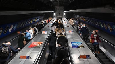 Travellers ride an escalator in a train station in London as England prepares to enter into a second lockdown in an effort to stem soaring infections. AFP