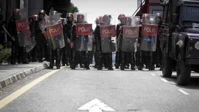 Police stand guard during a protest for the Malaysian opposition leader Anwar Ibrahim outside the Palace of Justice in Putrajaya. Joshua Paul / AP Photo