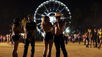 A country music fan talks with a friend while on his cell phone during the first day of the music festival. Mike Blake / Reuters