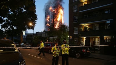 Police control a security cordon as a huge fire engulfs the Grenfell Tower in west London. Daniel Leal-Olivas / AFP Photo / June 14, 2017