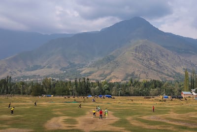 Kashmiri men play cricket on the outskirts of Srinagar. AP Photo