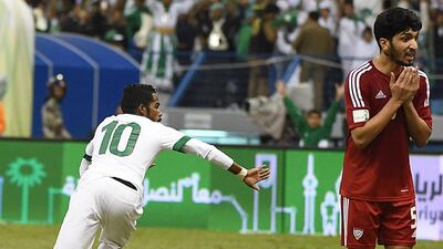 Saudi Arabia’s Nawaf Al Abid celebrates after scoring the team’s second goal as the UAE’s Amer Abdulrahman looks on. Fayez Nureldine / AFP