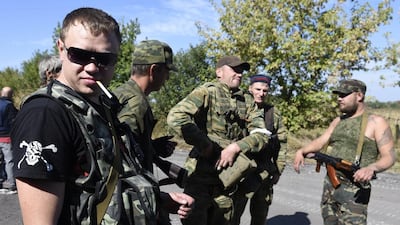 Pro-Russian forces at a checkpoint near Donetsk on the way to Mariupol in Ukraine. Kissinger suggests a system of sovereign powers with agreed spheres of influence could restore international order. Philippe Desmazes / AFP