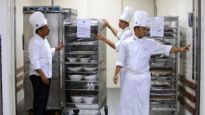 Chefs take food to the venue in the trolley at Dubai World Trade Centre in Dubai. Pawan Singh / The National