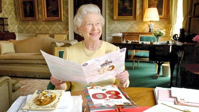 Queen Elizabeth sits in the Regency Room at Buckingham Palace as she looks at some of the cards which have been sent to her for her 80th birthday in 2006. Getty Images