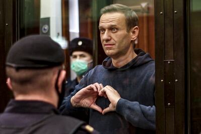 Alexei Navalny makes a heart symbol to his wife Yulia Navalnaya, at a Moscow City Court hearing in 2021. AP