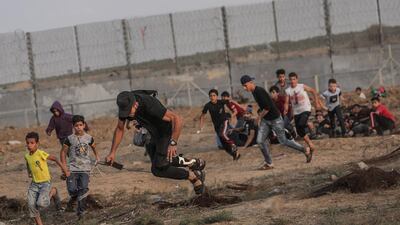 A protester is injured during clashes after the weekly Friday protests near the border between Israel and Gaza Strip. EPA