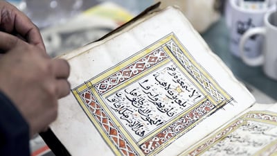 Salem Al Jadidi leafs through his archive collection.