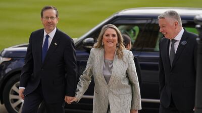 Israeli President Isaac Herzog arrives with his wife Michal for the reception. PA