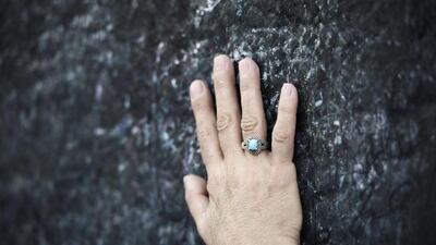 A Muslim pilgrim touches a rock as she prays on Mount Arafat, near Mecca, during one of the Hajj rituals on October 3, 2014. The pilgrims perform a series of rituals during the annual Hajj. They circumambulate the kaaba seven times, runs back and forth between the hills of Al-Safa and Al-Marwah, drink from the Zamzam Well, goes to the plains of Mount Arafat to stand in vigil, and throws stones in a ritual Stoning of Devil. The pilgrims then shave their heads, perform a ritual of animal sacrifice, and celebrate Eid al-Adha holiday. AFP PHOTO/MOHAMMED AL-SHAIKH