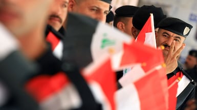 National fervour as Iraqi policeman join the queue to vote in the November election at a polling station in Baghdad. EPA