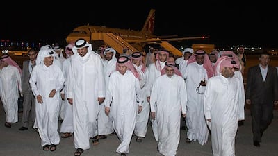 Emir of Qatar Sheikh Tamim bin Hamad Al Thani, second left in front row, receives the released Qataris at the Doha airport in Doha, Qatar on April 21, 2017. After nearly a year and a half in captivity, Qatar on Friday secured the release of 26 hostages, including members of its ruling family. Qatar News Agency via AP