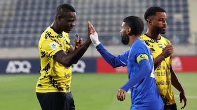 Al Ittifaq's Mario Balotelli embraces an Al Arabi player before kick-off.
