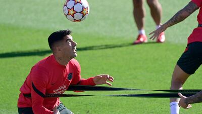Atletico Madrid forward Luis Suarez heads the ball during training in Majadahonda on the eve of their Champions League Group B match against AC Milan on Tuesday, Septembert 28. AFP
