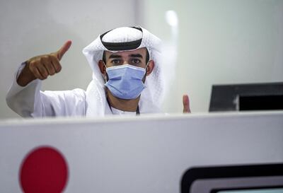 Abu Dhabi, United Arab Emirates, May 6, 2020. the new Ambulatory Healthcare Services, a SEHA Health System Facility, National Screening Project in Mussafah Industrial Area in Abu Dhabi. -- A testing center staffer gives the thumbs up sign. Victor Besa / The National Section: NA Reporter: Nick Webster