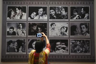 A visitor takes a picture of a display with images of Indian movie actors at the National Museum of Indian Cinema, the country's first museum showcasing the history of its film industry. AFP