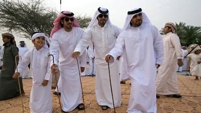 Men perform a traditional Arabic dance called the Razif at a wedding celebration for two grooms of the Shehhi tribe in the village of al Mahboobi in al Rams near Ras al Khaimah. Jeff Topping / The National