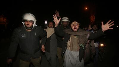 Pakistani police officers arrest a man at a protest against the acquittal of Asia Bibi in Lahore, Pakistan, Tuesday, January 29, 2019. AP