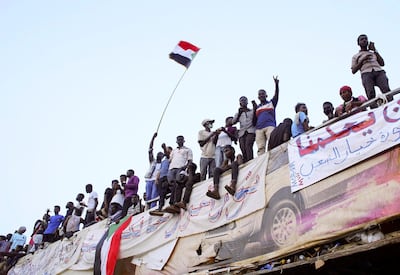 Demonstrators wave their national flag as they attend a protest rally demanding Sudanese President Omar Al-Bashir to step down outside Defence Ministry in Khartoum. Reuters