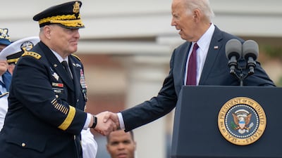 President Joe Biden shakes hands with Joint Chiefs Chairman Gen Mark Milley during a tribute ceremony outside Washington. AP