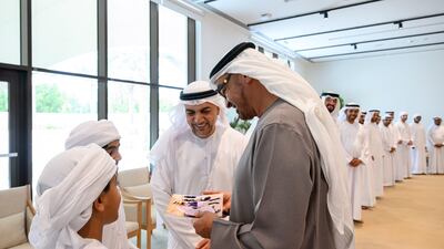 The President looks at a photograph during the reception