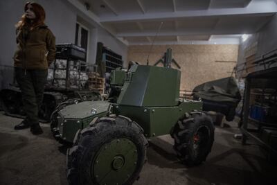A Ukrainian ground drone capable of carrying a machine gun on assault missions is repaired in the Kharkiv region. EPA