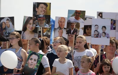 People gather near a monument for the victims of the Malaysia Airlines plane crash near the village of Grabovo in Ukraine's Donetsk region on July 17, 2018. Reuters