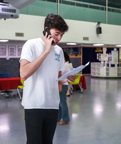 Lucas Dobbie Holman, 16, calls his parents after getting great results. Victor Besa/The National