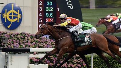 Tommy Berry rides Designs On Rometo the finish line ahead of Joao Moreira riding Military Attack at the Sha Tin racecourse in Hong Kong on Sunday. Anthony Wallace / AFP