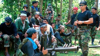Abu Sayyaf spokesman Abu Sabaya, right foreground, is seen with his band of armed extremists. Philippine troops captured an Abu Sayyaf rebel commander blamed for years of ransom kidnappings. AP Photo