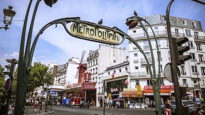 The cabaret Moulin Rouge, as seen from the entrance of the Metro station Blanche, in the revitalised Paris district of Pigalle. iStockphoto.com