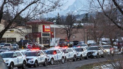 Law enforcement vehicles line up at the perimeter of a shooting site at a King Soopers grocery store. Reuters