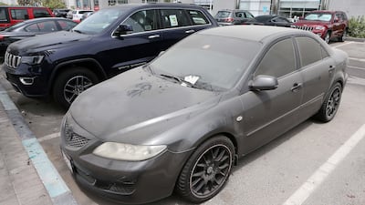 A dirty car with the fine ticket parked in the parking area near the Corniche in Abu Dhabi. Pawan Singh / The National