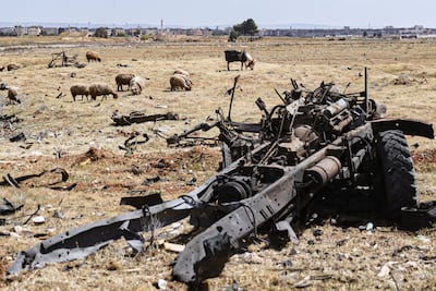 The wreckage of a vehicle sits amid the debris left by an Israeli strike on a military airbase near Hama. AP