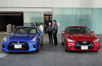A Nissan staff member speaks with a customer at the company's global headquarters in Yokohama. EPA