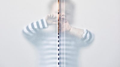 Arlo plays eye spy through a gap in the patio screen. Rory Trappe/NPG