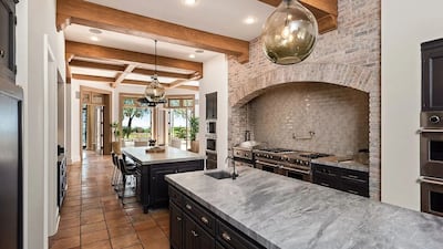 The kitchen has grey marble islands