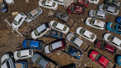 Damaged vehicles are surrounded by mud after flooding in Poza Rica, eastern Mexico. AP