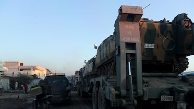 Turkish military vehicles enter the Bal al-Halwa crossing at the Syrian-Turkish border, in Idlib governorate, Syria. REUTERS